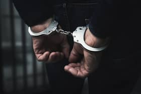 arrested man with cuffed hands