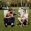 People enjoying the sunny weather in St James's Park in London.