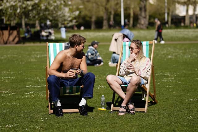 People enjoying the sunny weather in St James's Park in London.