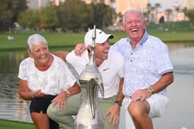 Northern Ireland's Rory McIlroy sharing a joke with parents Rosie and Gerry as they pose with the Hero Dubai Desert Classic trophy following yesterday's title-winning final round at Emirates Golf Club. (Photo by Ross Kinnaird/Getty Images)