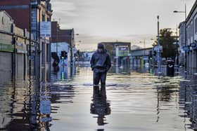 Michael McShane walks through flood water on Market Street in Downpatrick, Northern Ireland. Some rivers in Northern Ireland reached record high levels following several days of heavy rain. Picture date: Thursday November 2, 2023.