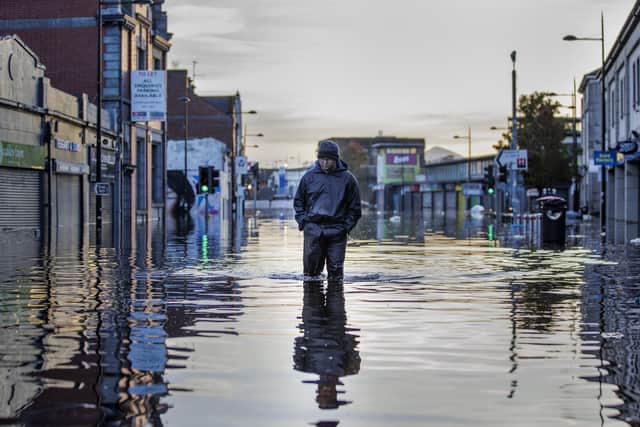 Michael McShane walks through flood water on Market Street in Downpatrick, Northern Ireland. Some rivers in Northern Ireland reached record high levels following several days of heavy rain. Picture date: Thursday November 2, 2023.
