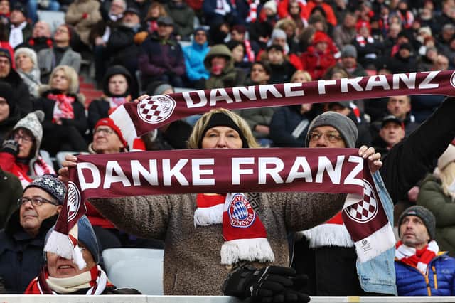 Spectators display tribute scarves during a memorial service for football legend Franz Beckenbauer at Allianz Arena in Munich, Germany. (Photo by Alexandra Beier/Getty Images)