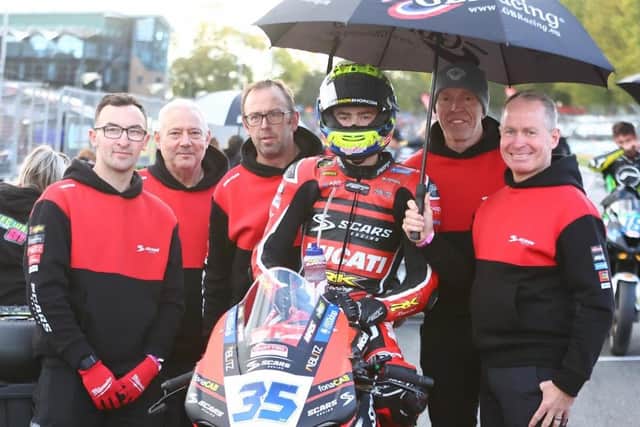 Dungannon teenager Jack Burrows on the Scars Racing Ducati with his dad John (second from right) and his team at Brands Hatch. (Photo credit: Scars Racing)