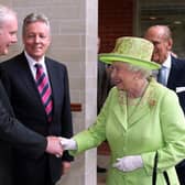 Britain's Queen Elizabeth II (2nd R) shakes hands with Northern Ireland Deputy First Minister Martin McGuinness (L) watched by First Minister Peter Robinson (2nd L) and Prince Philip (R) at the Lyric Theatre in Belfast, in 2012. If the former IRA commander, the late Mr McGuinness, could shake hands with the late Queen, Sinn Fein will milk the coronation politically (Photo by PAUL FAITH/AFP via Getty Images)