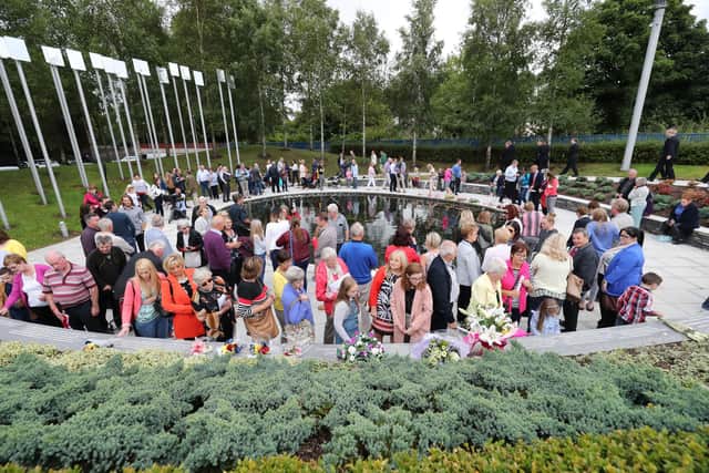 People visit the Omagh Memorial garden after attending a ceremony for victims of the car bomb on Market Street on the 15th August 1998 Picture: Niall Carson/PA Wire