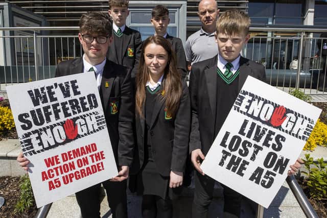 Peter Canavan (back right), director of sport at Holy Trinity College Cookstown standing with students at Strule Arts Centre in Omagh where a public inquiry is being held examining the proposals for a new dual carriageway along the route of the A5 in Northern Ireland.