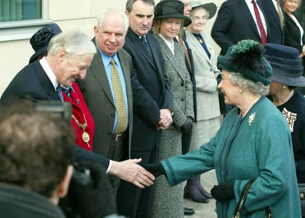 Queen Elizabeth II is greeted by The Rt Hon Sir Robert Carswell, Lord Chief Justice of Northern Ireland, in Belfast after she offically opened the Laganside Court Complex. 