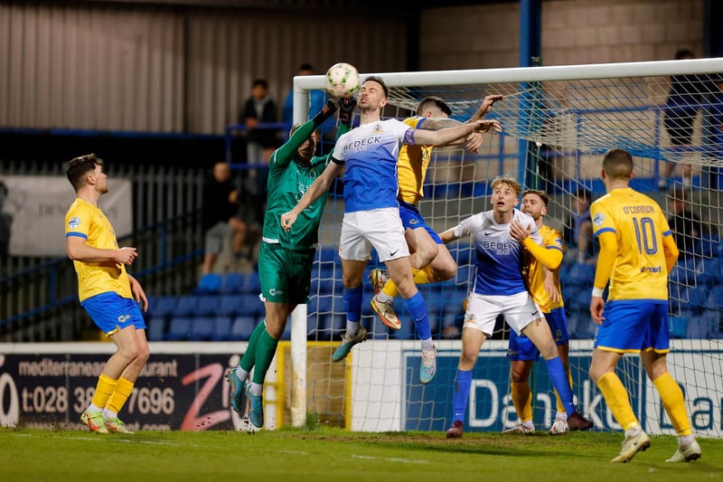 Glenavon's Matthew Fitzpatrick and Dungannon Swifts goalkeeper Declan Dunne challenge for the ball