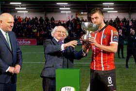 President Michael D. Higgins presents the President’s Cup to Derry City football captain Will Patching at the Brandywell on Friday evening.  President Higgins' relaxed attendance was as though he was at home. Photo: George Sweeney