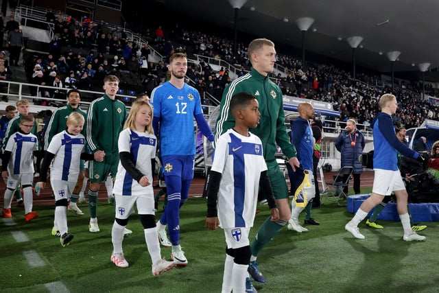 Northern Ireland captain George Saville leads the team out making his 50th International appearance