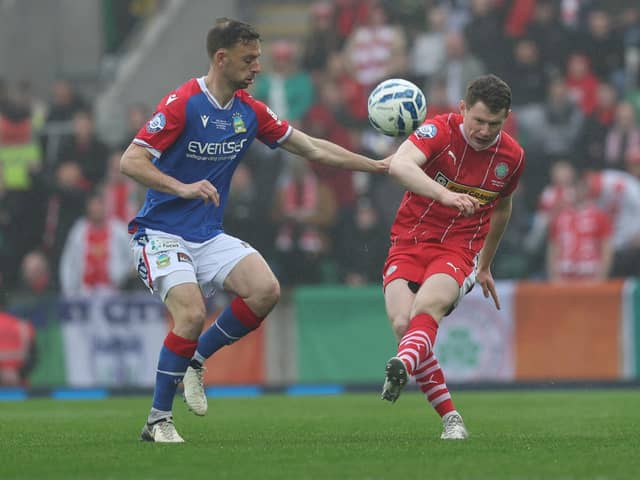 Cliftonville defender Paddy Burns (right) helped the Reds win the Irish Cup for the first time in 45 years after a 3-1 win against Linfield