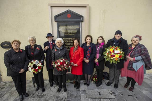From left, Joan Anderson with her sister Margaret Veitch, children of William and Agnes Mullan, injured victim Jim Dixon with wife Anna, Pamela Whitley, Stella Robinson, Moyna Nesbitt and Julian Armstrong, children of Wesley and Bertha Armstrong, and Aileen Quinton daughter of Alberta Quinton, take part in an act of remembrance to mark the 35th anniversary of the Enniskillen bomb, at the newly installed memorial in Enniskillen, Co Fermanagh.