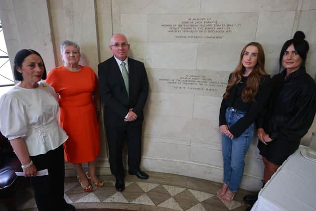 From left to right, family friend Betty Gilmore, Mairead Burke (Paddy Wilson's niece), Paul Wilson (Paddy Wilson's son), Joanne and Karen Wilson (Paddy Wilson's granddaughters) standing beside a memorial during an event at Stormont marking the 50th anniversary of the murder of SDLP senator Paddy Wilson. 
Photo: Liam McBurney/PA Wire