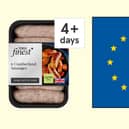 A Tesco pack of sausages from Cumberland, next to an EU flag
