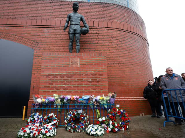 Floral tributes at the John Greig statue in memory of the 66 Rangers supporters who lost their lives in the 1971 Ibrox Disaster. Photo: Steve Welsh/PA Wire