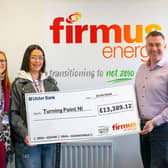 Sarah McClenaghan and Trudi Power from Turning Point NI are presented with a cheque for £13,389.12.