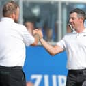 Northern Ireland's Rory McIlroy (right) celebrates with playing partner Shane Lowry after the pair's birdie finish on the 18th to force a playoff to settle the Zurich Classic of New Orleans at TPC Louisiana. (Photo by Jonathan Bachman/Getty Images)