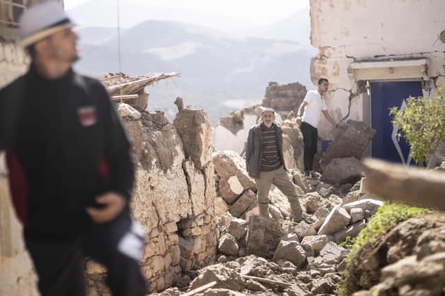 People inspect their damaged homes after an earthquake in Moulay Brahim village, near Marrakech, Morocco, Saturday, Sept. 9, 2023. (AP Photo/Mosa'ab Elshamy)