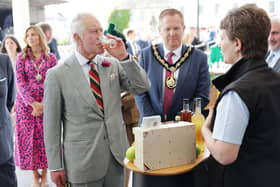 King Charles III samples local produce during a Celebration of Culture at Market Theatre Square in Armagh. King Charles III and Queen Camilla are visiting Northern Ireland for the first time since their Coronation. Picture: Chris Jackson/Getty Images