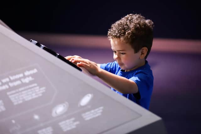 A young vsitor explores the new exhibition at Armagh Observatory and Planetarium