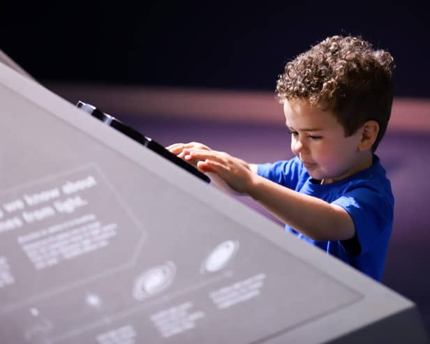 A young vsitor explores the new exhibition at Armagh Observatory and Planetarium