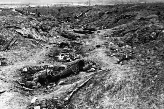 A scene in one of the German trenches in front of Guillemont, near Albert, during the Battle of the Somme. It shows the havoc wrought by the British bombardment, with German dead visible in the photograph. Guillemont was captured by the British in late September, 1916.:-