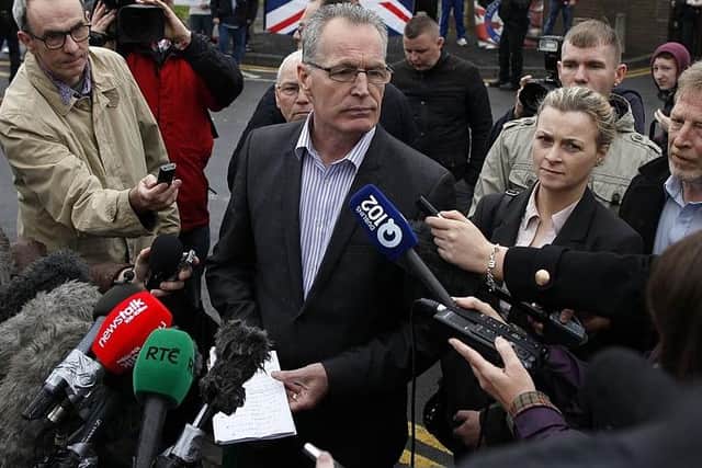 Republican party Sinn Fein's Gerry Kelly (C) speaks to the media in front of Antrim Police station in Antrim Northern Ireland May 4, 2014 as Sinn Fein leader Gerry Adams spent a fourth day being questioned over an infamous IRA murder