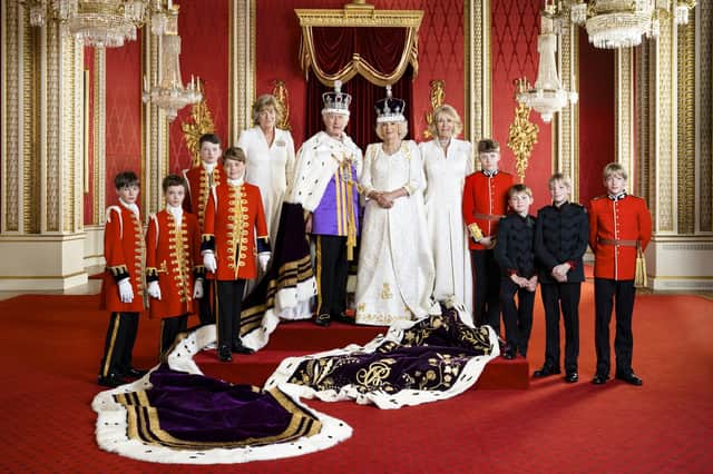 King Charles III and Queen Camilla with their Pages of Honour and Ladies in Attendance on the day of the coronation in the Throne Room at Buckingham Palace, London. Pictured (left to right) Ralph Tollemache, Lord Oliver Cholmondeley,  Nicholas Barclay, Prince George, the Marchioness of Lansdowne, King Charles III, Queen Camilla, the Queen's sister Annabel Elliot, the Queen's grandson Freddy Parker Bowles, the Queen's great-nephew Arthur Elliot, and the Queen's grandsons Gus Lopes and Louis Lopes. The King is wearing the Imperial State Crown, and Robe. Hugo Burnand/Royal Household 2023.