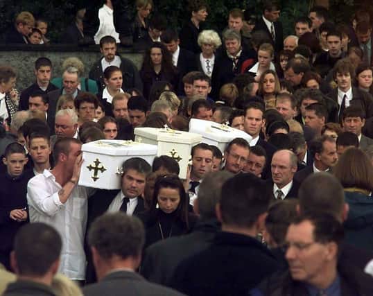 The three coffins of brothers Richard, Mark, Jason Quinn who were killed in a sectarian arson attack are carried by family and mourners to Rasharkin Church for burial, after leaving a funeral mass at the Church of  Our Lady and St Patricks, Ballymoney. The murders of three young children in Ballymoney were recorded as having "changed the mood" in Northern Ireland following a period of sustained violence at the height of the Drumcree standoff in 1998.