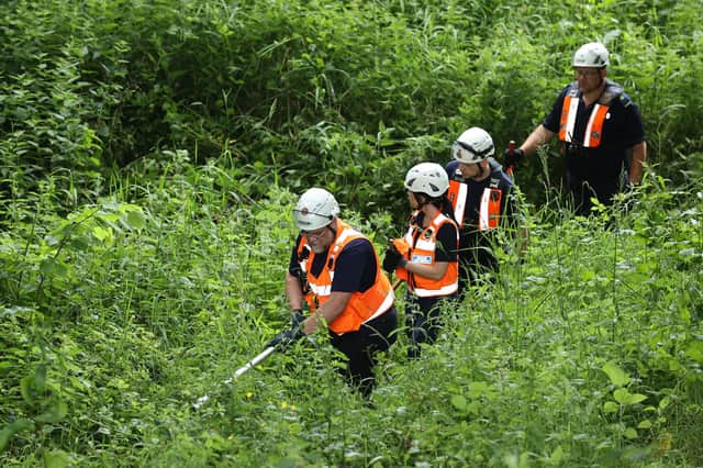 Community Rescue Service volunteers in thick undergrowth near the River Braid in Ballymena during the search for Chloe Mitchell, who was last seen on CCTV in the early hours of June 3 in Ballymena town centre.