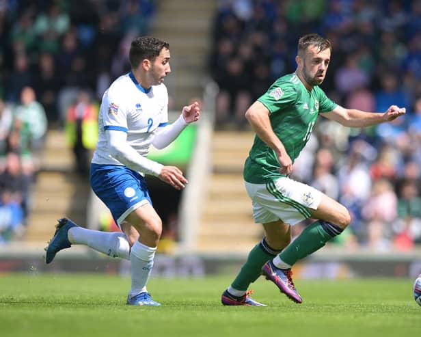 Conor McMenamin of Northern Ireland runs with the ball away from Andreas Panayiotou Filiotis of Cyprus during the UEFA Nations League League C Group 2 match between Northern Ireland and Cyprus at Windsor Park on June 12, 2022 in Belfast, Northern Ireland. PIC: Charles McQuillan/Getty Images