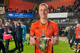 Sam McClelland pictured with the Scottish Championship trophy during his loan spell at Dundee United