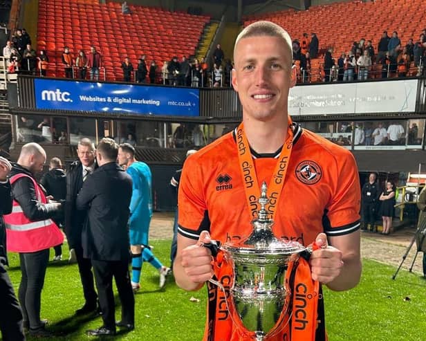 Sam McClelland pictured with the Scottish Championship trophy during his loan spell at Dundee United