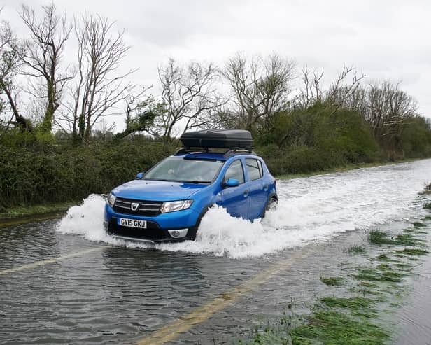 A car drives through flood water in Littlehampton, West Sussex, after the River Arun burst its banks overnight. Photo: Gareth Fuller/PA Wire