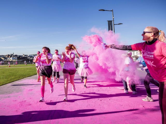 Runners, walkers, and pooches were splashed in pink powder from head to toe for a great cause as Cancer Focus NI’s first Pink Run took place in Londonderry. Picture Steven McAuley/McAuley Multimedia