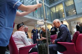 King Charles and Queen Camilla meet with Lesley Woodbridge, a patient receiving the second round of chemotherapy for sarcoma and her husband Roger Woodbridge, during a visit to University College Hospital Macmillan Cancer Centre, London