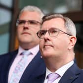 Sir Jeffrey Donaldson is stepping down as leader of the Democratic Unionist Party 'with immediate effect' after the DUP said he had been charged with allegations of a historical nature. Pictured behind Sir Jeffrey is the new party leader, East Belfast MP Gavin Robinson