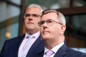Sir Jeffrey Donaldson is stepping down as leader of the Democratic Unionist Party 'with immediate effect' after the DUP said he had been charged with allegations of a historical nature. Pictured behind Sir Jeffrey is the new party leader, East Belfast MP Gavin Robinson