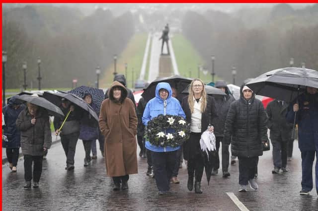Dympna Kerr (centre), sister of Columba McVeigh carries a wreath as she leads a group on the 16th annual All Souls Silent Walk for the Disappeared at Stormont.