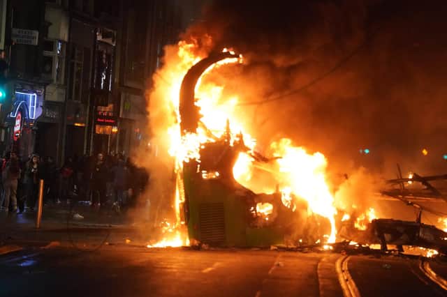A bus on fire on O'Connell Street in Dublin city centre after violent scenes unfolded following an attack on Parnell Square East where five people were injured, including three young children. Photo: Brian Lawless/PA Wire