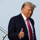 Ex President Trump steps off his plane in Atlanta, Georgia on Thursday. He faces seven trials, which will have him in and out of court in 2024 even if he does not end up in jail. That Mr Trump surrendered to the Georgia authorities for trying to overturn that state’s 2020 election results showed that he cannot evade the legal process (AP Photo/Alex Brandon)