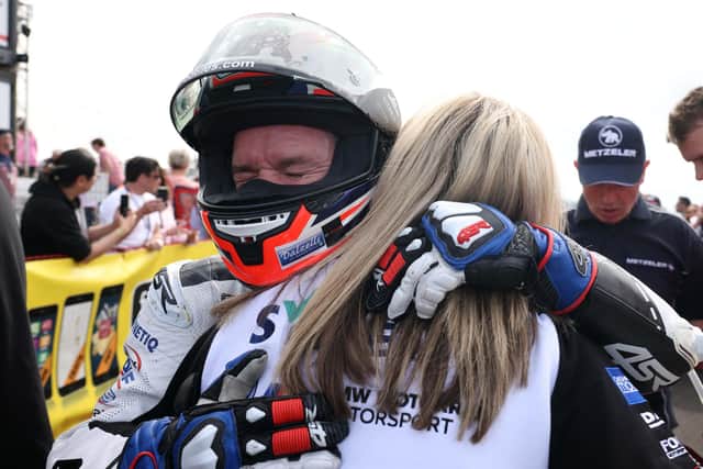 Alastair Seeley celebrates his victory in the Superstock race with wife Danni