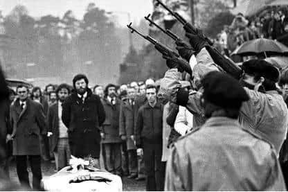 Gunmen fire over the coffin of hunger striker Bobby Sands in 1981. He had been in prison since 1976 after shooting at police and planting a bomb at a furniture shop.