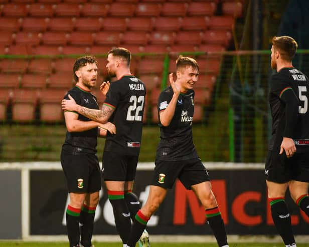 Glentoran players celebrate Shay McCartan's goal against Newry City at the Oval
