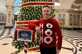 SDLP Belfast Councillor Gary McKeown is inviting visitors to City Hall the chance to make a donation to charity if taking selfies at the council's Christmas tree.