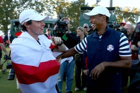 Northern Ireland golfer Rory McIlroy, clad in the Ulster Banner, talks to Tiger Woods after Europe defeated the USA in the 2012 Ryder Cup