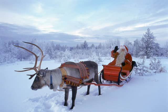 Santa Claus waves in Rovaniemi, Finnish Lapland, 23 December 2005.  (Photo credit should read MARTTI KAINULAINEN/AFP/Getty Images)