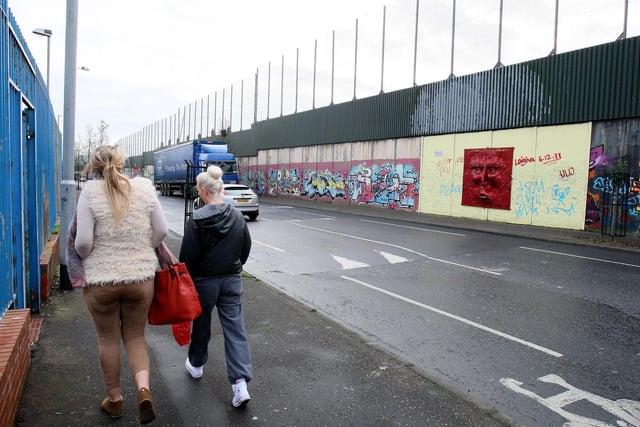 The largest peace wall in Belfast, at Cupar Way, which separates the Catholic Falls area and the Protestant Shankill area of the city, as a majority of young people would leave Northern Ireland because of lack of job opportunities, a report said