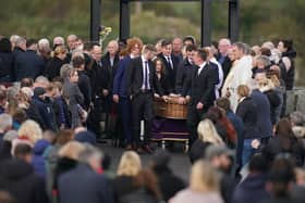 Robert Garwe's partner Aine pushes her daughters coffin from St Michael's Church, in Creeslough, after the funeral mass of Robert Garwe and their five-year-old daughter Shauna Flanagan Garwe, who died following an explosion at the Applegreen service station in the village of Creeslough in Co Donegal. Picture date: Saturday October 15, 2022.